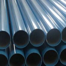 Marmon Keystone A close-up view of several stacked, shiny blue metal tube pipes arranged in parallel rows, with horizontal red bars supporting the pipes—perfect for any supplychain distributor in the metals industry.