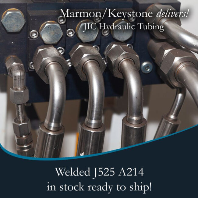 Marmon Keystone Close-up view of metal hydraulic tubes connected to fittings, highlighting Marmon/Keystone as your trusted metals distributor for JIC hydraulic tubing—welded J525 A214—available in stock and ready to ship for your supplychain needs.