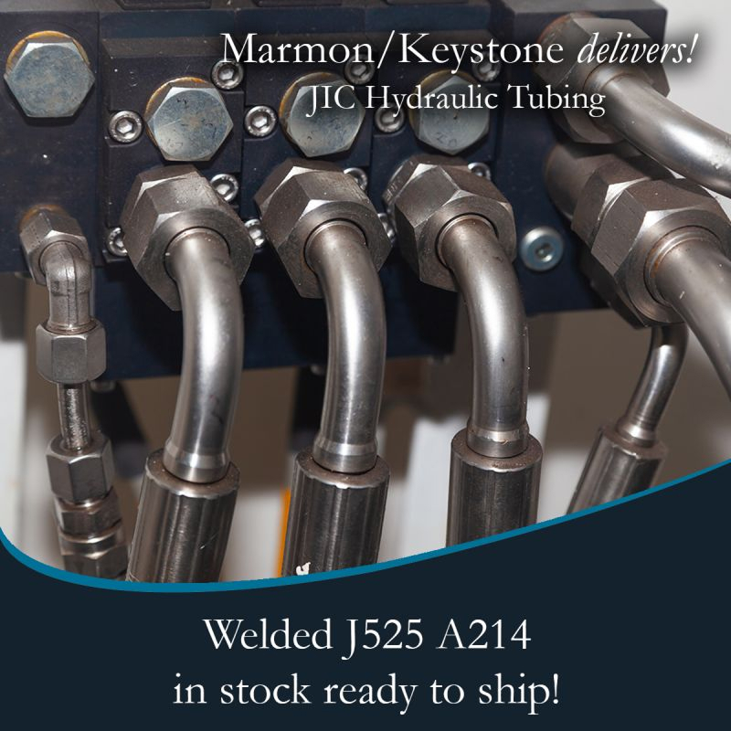 Marmon Keystone Close-up view of metal hydraulic tubes connected to fittings, highlighting Marmon/Keystone as your trusted metals distributor for JIC hydraulic tubing—welded J525 A214—available in stock and ready to ship for your supplychain needs.