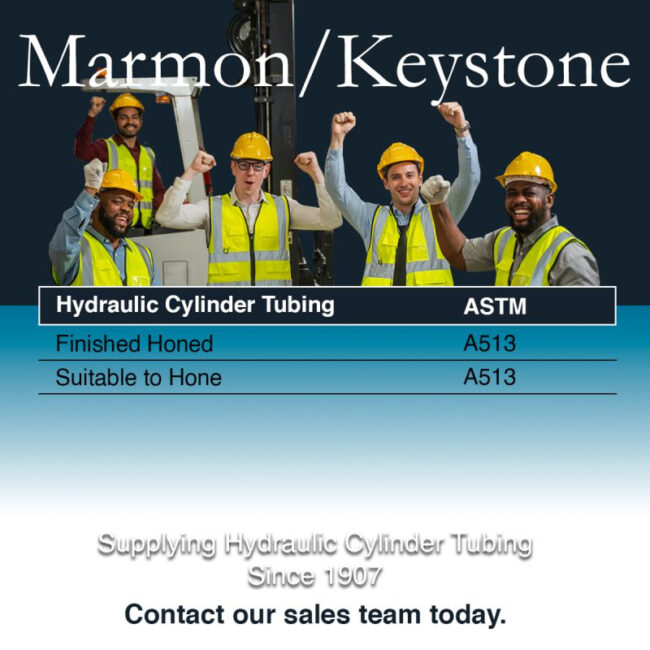 Marmon Keystone Five workers in safety vests and helmets stand before industrial equipment, raising their fists and smiling. Text below lists hydraulic cylinder tube and bar specifications and contact info for Marmon/Keystone, your trusted metals distributor.